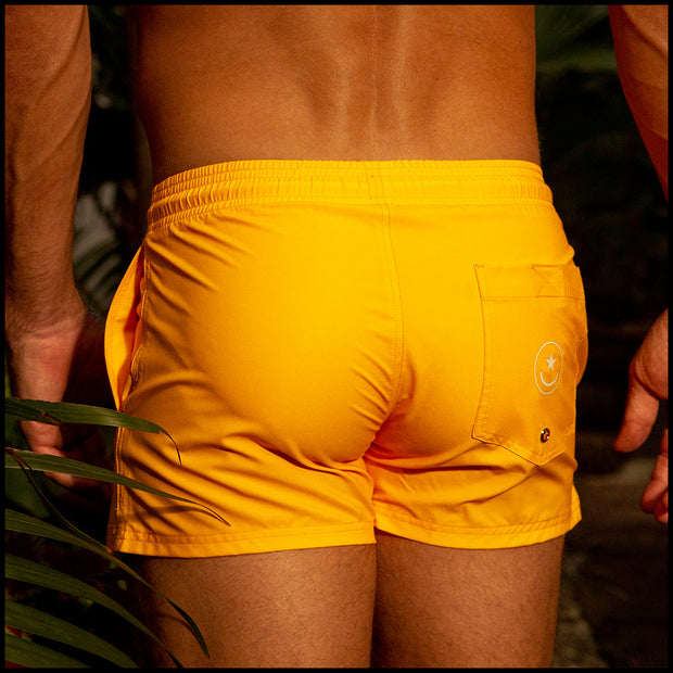 Back view of the RADIANT YELLOW beach trunks for men by BANG! menswear Miami in sunny yellow color.