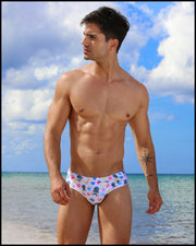 Frontal view of model wearing the HEY MISTER TJ (POOLSIDE MIX) Men’s bikini-style bottoms in white with colorful headphones and disc shapes and a dj tiger print by Bang! men's beachwear.