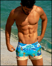 Male model's view showing the 8-BIT WILD BEACH PARTY beach shorts for men with vintage  sprite graphics of  Atari video game, Nintendo, Sega, Commodore 64