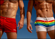 Male model wearing the FOUREVER STRIPES VOL 2 men's bikini-style bottoms. Next, another model wearing red Mini-Shorts by the Bang! Clothes brand of men's swimwear from Miami.
