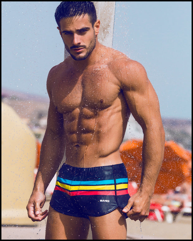 Frontal view of model wearing the BIONIC Stripes men’s swimsuit by the Bang! brand of men&