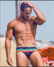 Frontal view of model wearing the BIONIC Stripes men’s swimsuit by the Bang! brand of men's beachwear from Miami.