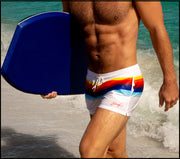 Side view of STRIPES ON 45 men’s beach trunks in white with rainbow colored bands by Bang! 80s California Surfer 