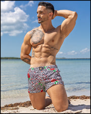Male model at the beach wearing his SO RED THE ROSE Mini Shorts by BANG! Clothes Miami the official brand of mens swimsuits.
