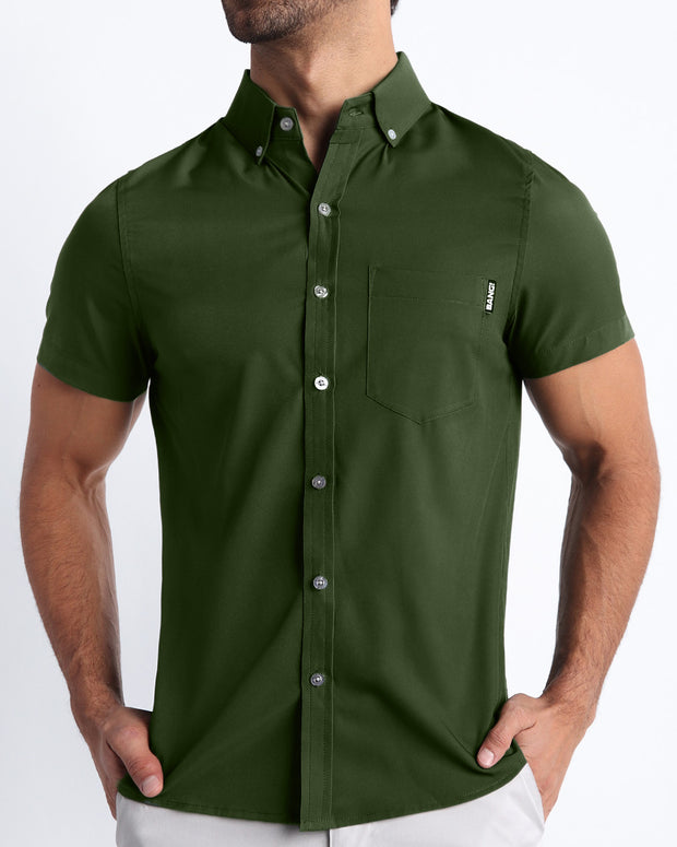 Front view of a sexy male model wearing ALPHA GREEN mens short-sleeve stretch shirt in a military green color by the Bang! brand of men&