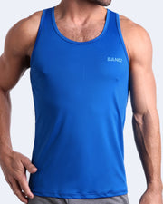 Frontal view of male model wearing the ASTRAL BLUE beach tank top for men by the Bang! brand of men's beachwear from Miami.