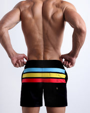 Back side of the BIONIC STRIPES beach mens Resort Shorts swimsuit in black color with color stripes in turquoise blue, yellow, and red by BANG! Clothes in Miami.