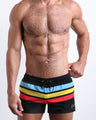 Male model wearing the Bionic Stripes men's beach shorts by the Bang! Clothes brand of men's swimwear from Miami.