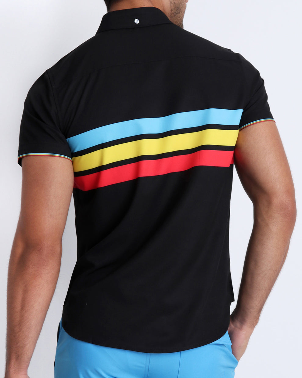 Back side view of male model wearing a men's stretch shirt in black color with color stripes in turquoise blue, yellow, and red.