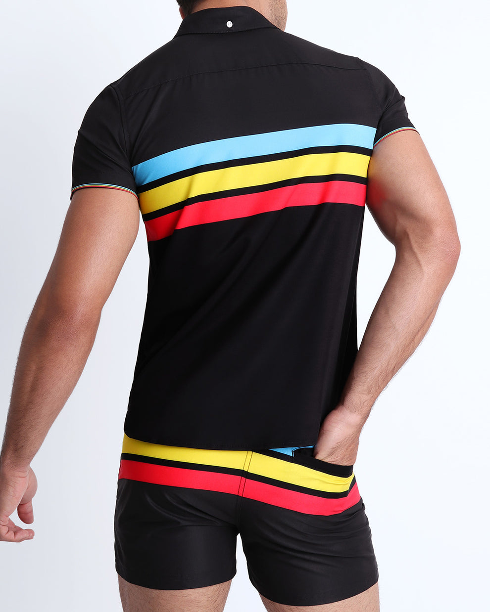 Back side view of male model wearing a men's stretch shirt in black color with color stripes in turquoise blue, yellow, and red.