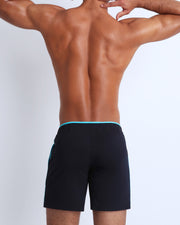 Back view of the men's above-knees length fitness workout shorts in a solid dark black color by BANG! menswear Miami.