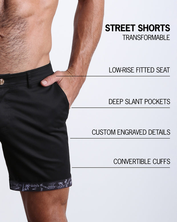 Men tailored fit chino shorts in BLACK KNACK by Bang! Keeps you feeling comfortable and looking sharp all. Classic chino shorts for men in a cotton blend from Bang! Clothing from Miami. Features two front pockets and custom engraved button front closure with zip fly. Can roll-up cuffs for shorter length and showing internal print. Or hem down for a mid-thigh length and full-solid black color showing.