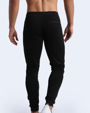 Back view of men's high quality outdoor track pants in a solid black color with back zippered pocket. Suitable for daily, running, working out, exercise and hanging out in Winter.
