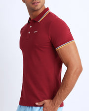 Side view of a male model wearing a slim fit sexy collared shirt for men from BANG! Miami in stone burgundy color. 