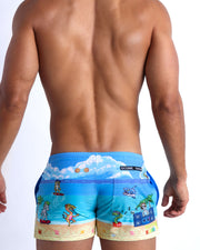 Male model's back view showing the 8-BIT WILD BEACH PARTY beach shorts for men with vintage  sprite graphics of  Atari video game, Nintento, Sega, Commodore 64