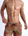 Frontal view of model wearing the CATS N'ROSES men’s beach shorts featuring leopard print in brown tones with red roses by the Bang! menswear brand.