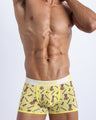 Front view of a sexy male model wearing a BANG! Cotton Boxer Briefs for men in a soft yellow features a fun pineapple print with the hashtag forever wild offering a perfect fit. Offers stay-put leg design that prevents chafing and riding up the leg.