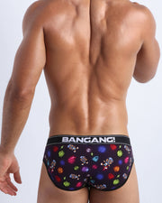Back view of model wearing the HEY MISTER TJ (CLUB MIX) cotton brief underwear Men by BANG! with clubbing and disc-jockey details in dark colors made by the Bang! official brand of men's beachwear.
