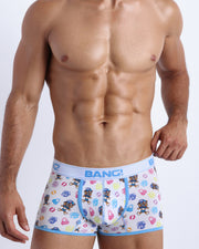 Front view of a sexy male model wearing a BANG! Cotton Boxer Briefs for men in white with headphones and vynil disc. Offers stay-put leg design that prevents chafing and riding up the leg. 