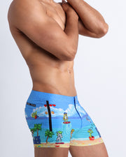 Side view of a man wearing the 8-BIT WILD BEACH PARTY Summer men's swimsuit  by Bang! Clothes with 80s Sega video game graphics.