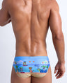 Male model's back view showing the 8-BIT WILD BEACH PARTY beach briefs for men with vintage  sprite graphics of  Atari video game, Nintendo, Sega, Commodore 64