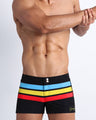 Frontal view of model wearing the BIONIC Stripes men’s swimsuit by the Bang! brand of men's beachwear from Miami.