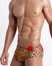 Right side view of an in-shape men's torso wearing a sexy Brazilian sunga men swimsuit by Bang! Clothes in brown leopard animal print with red roses.