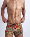 Frontal view of model wearing the CATS N'ROSES men’s mini shorts featuring leopard print in brown tones with red roses by the Bang! menswear brand.