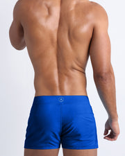 Back view of the CLUB BLUE beach trunks for men by BANG! menswear Miami in bright blue color.