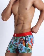 Side side view of a sexy in-shape men's torso wearing DISCO JUNGLE shorts swimsuit by the Bang! brand of menswear from Miami. 