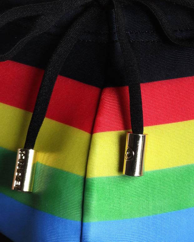 Close-up view of inseam and details of FOREVER STRIPES VOL 1 swimsuit for men, with black cord and custom branded golden cord-ends, and matching custom eyelet trims in gold.