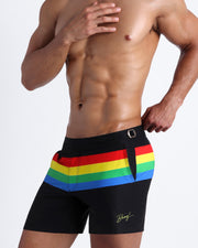 Side view of the FOUR EVER STRIPES VOL 1 swimsuit for men in dark black with stripes in red, yellow, blue and green by Bang! Clothing of Miami.