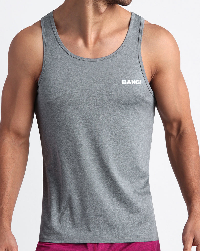 Frontal view of male model wearing the GREY MATTERS in a solid dark grey gym tank top for men by the Bang! brand of men's beachwear from Miami.