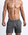 Frontal view of male model wearing the GROOVEJET jogger shorts in a solid dark grey quick-dry by the Bang! brand of men's beachwear from Miami.