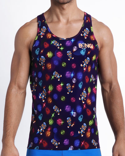 Frontal view of model wearing the HEY MISTER TJ (CLUB MIX) Men’s cotton beach tank top in dark tones with colorful headphones and disc shapes and a dj tiger print..