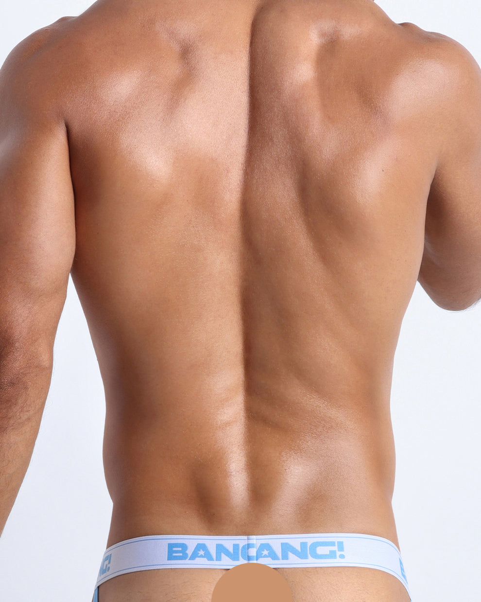 Back view of model wearing the HEY MISTER TJ (HOT MIX) Men’s beathable cotton jockstrap for men by BANG! with clubbing and disc-jockey details in dark colors. Offers light compression for perfect contouring to the body and second-skin fit.
