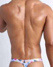 Back view of a sexy male model wearing HEY MISTER TJ (POOLSIDE MIX) men’s swimwear made by the Bang! official brand of men's beachwear.