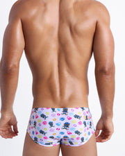 Back view of a sexy male model wearing HEY MISTER TJ (POOLSIDE MIX) men’s swimwear made by the Bang! official brand of men's beachwear.