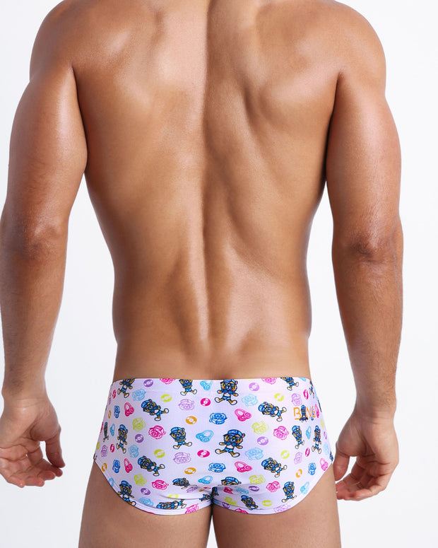 Back view of a sexy male model wearing HEY MISTER TJ (POOLSIDE MIX) men’s swimwear made by the Bang! official brand of men&