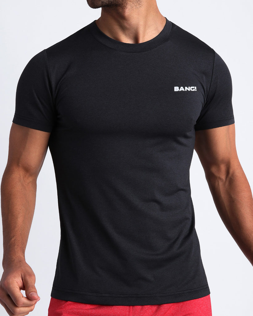 Frontal view of male model wearing the IRON BLACK in a solid black quick-dry workout shirt by the Bang! brand of men's beachwear from Miami.