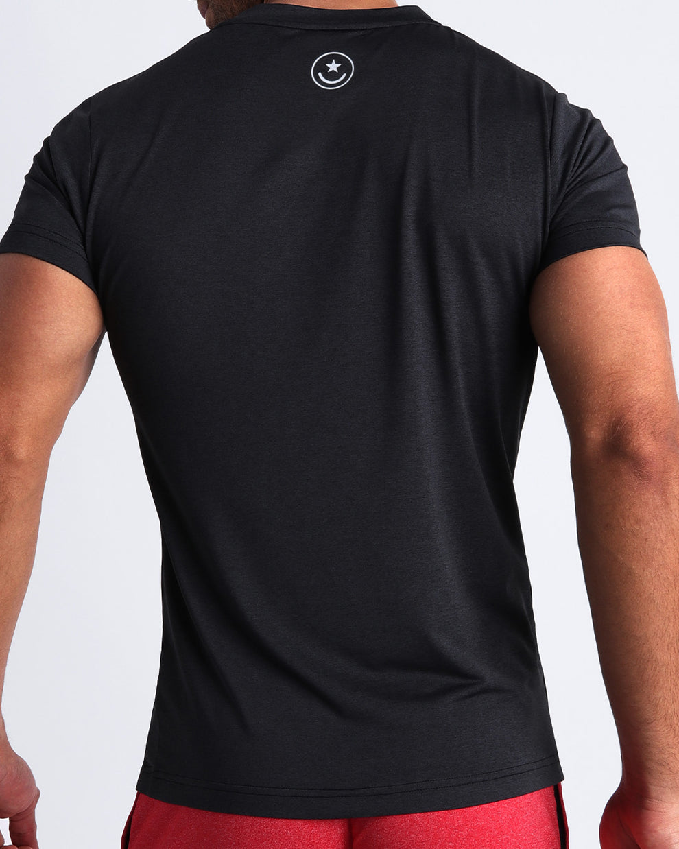 Back view of the IRON BLACK men's fitness shirt in a jet black color by BANG! menswear Miami.