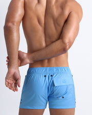Back view of the MAGNET BLUE beach trunks for men by BANG! menswear Miami in an light blue color.