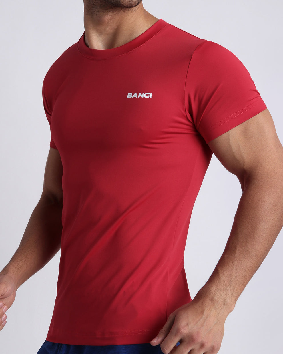 Side view of men’s exercise tee in a red color made by BANG! Clothing the official brand of mens beachwear. 