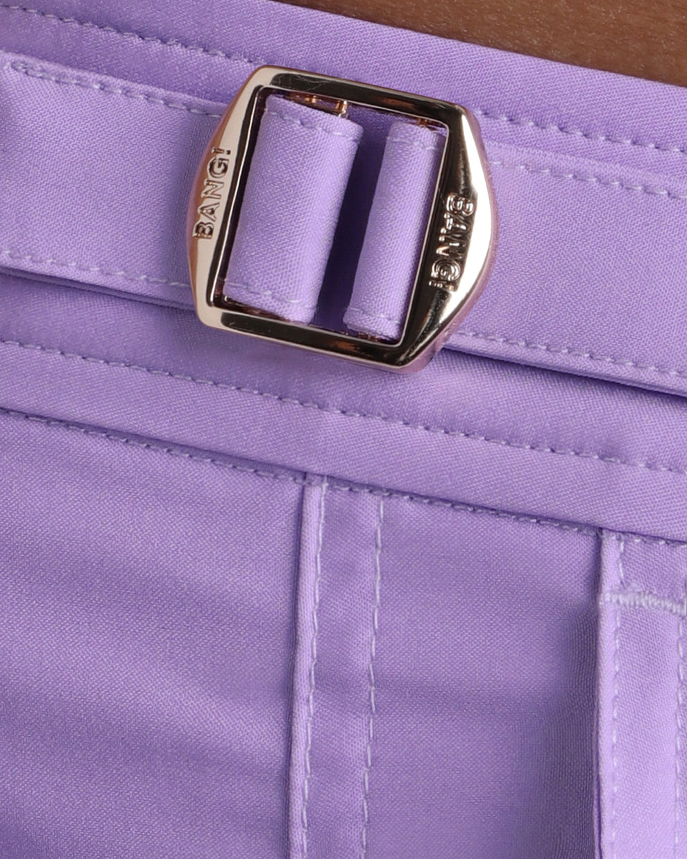 Close-up view of the NEO VIOLET men’s swimwear, showing custom branded golden adjustable side buckles.