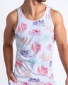 Frontal view of the OH L'AMOUR men’s beach tank top in white with colorful scenes of iconic couples kissing and in love.