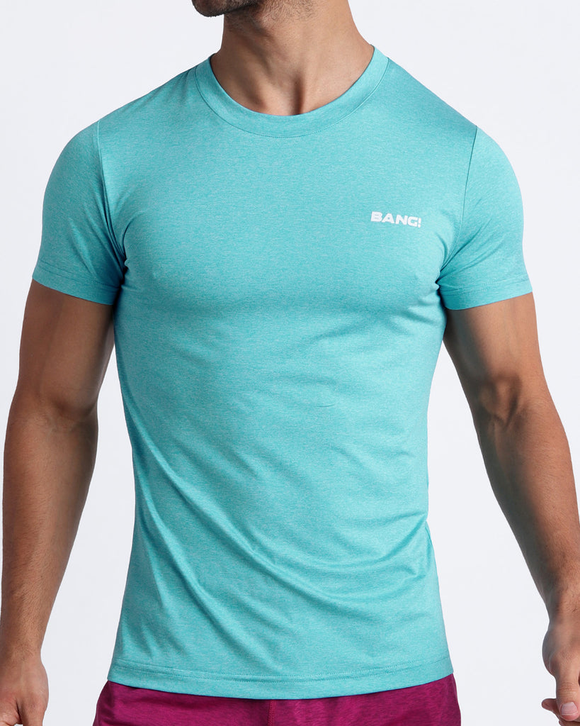 Frontal view of male model wearing the OLYMPIC BLUE in a solid aqua quick-dry workout shirt by the Bang! brand of men's beachwear from Miami.