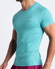 Side view of men’s exercise tee in a light turquoise color made by BANG! Clothing the official brand of mens beachwear. 