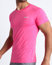 Side view of men’s exercise tee in a hot pink color made by BANG! Clothing the official brand of mens beachwear. 