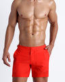 Frontal view of model wearing the PRIME RED men’s swim tailored shorts featuring a bold red color by the Bang! brand of men's beachwear from Miami.