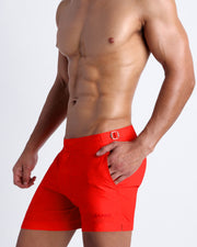 Side view of men’s shorts in bright red color made by Miami-based Bang Clothing of men's beachwear